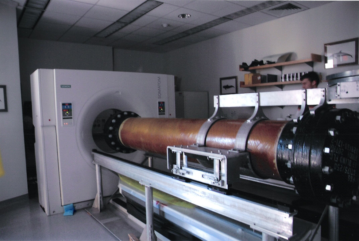 A large tube in front of a CT scanner